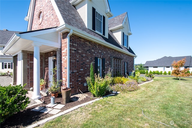 view of property exterior with a lawn