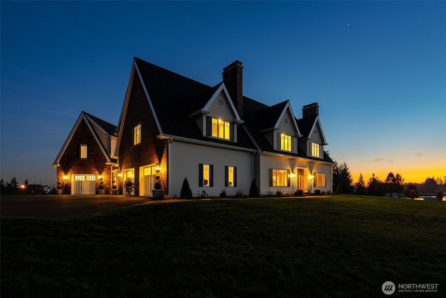 view of front of house with a lawn and a chimney