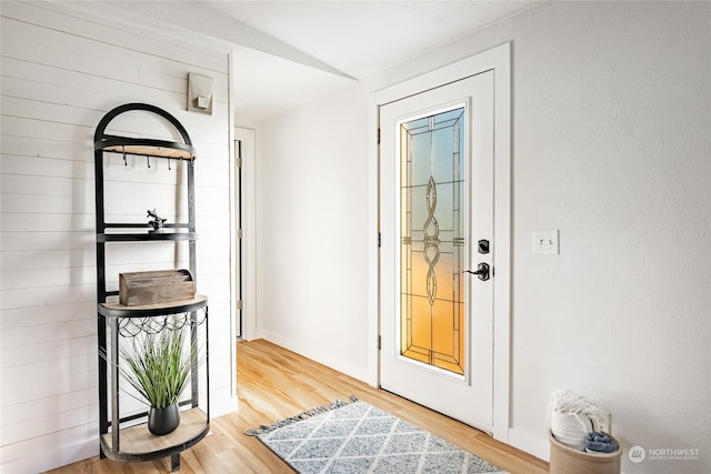 doorway to outside with wood-type flooring