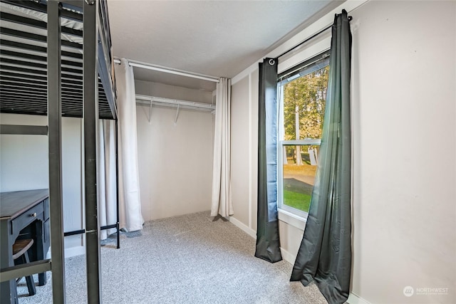 bedroom with light carpet and a closet