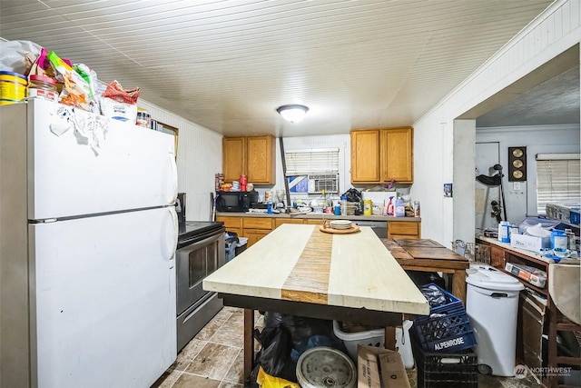 kitchen featuring ornamental molding and black appliances