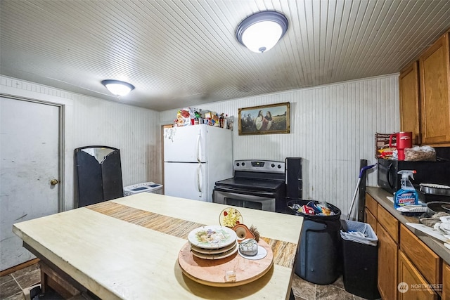 kitchen featuring white fridge and stainless steel range with electric cooktop