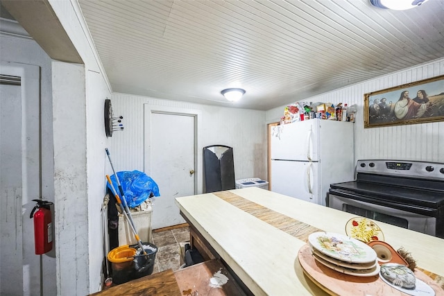 kitchen with stainless steel range with electric stovetop and white refrigerator