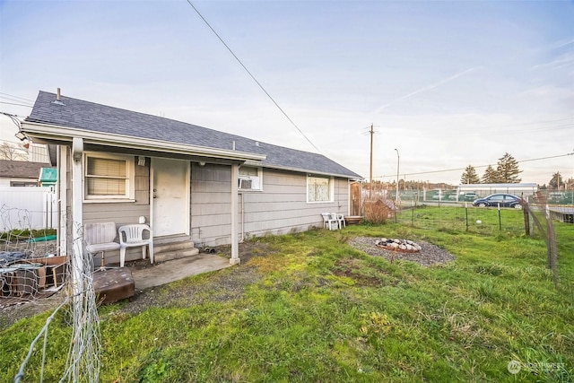 rear view of house featuring a lawn