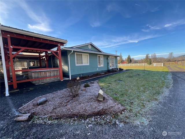 view of side of property with a lawn