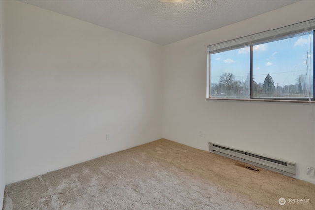 unfurnished room with a textured ceiling, light colored carpet, and a baseboard heating unit