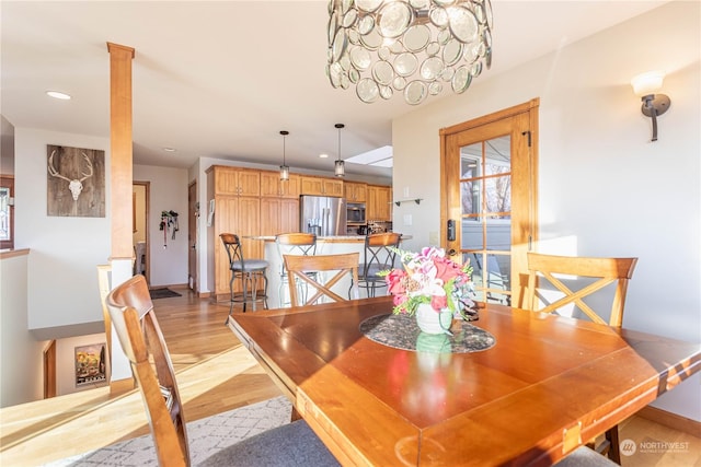 dining space with light hardwood / wood-style flooring