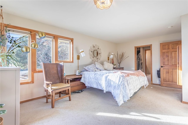 bedroom featuring a spacious closet and light colored carpet