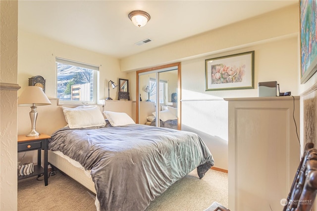 carpeted bedroom with a closet