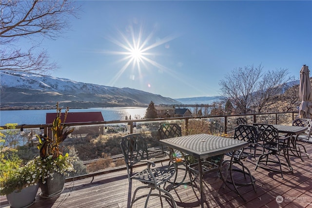 wooden terrace with a water and mountain view