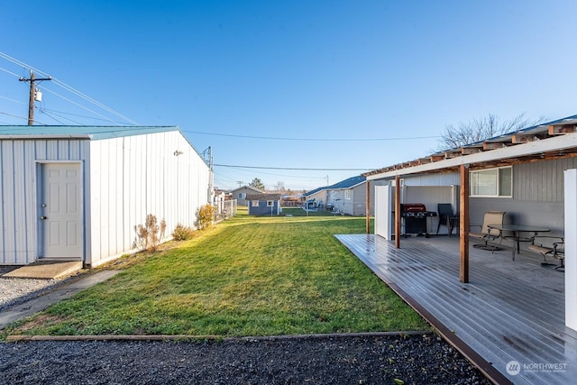 view of yard featuring a storage shed and a wooden deck