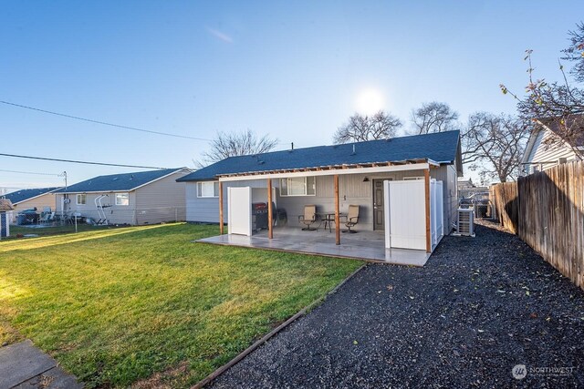 rear view of house with a patio area, a yard, and central AC unit