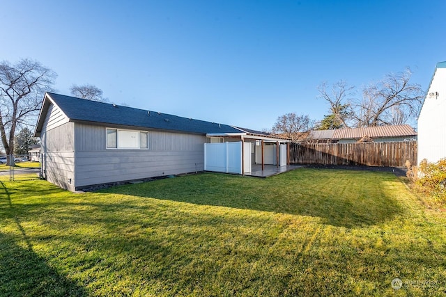 rear view of house with a yard