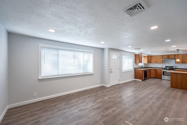 kitchen featuring pendant lighting, dishwasher, dark wood-type flooring, electric stove, and a textured ceiling