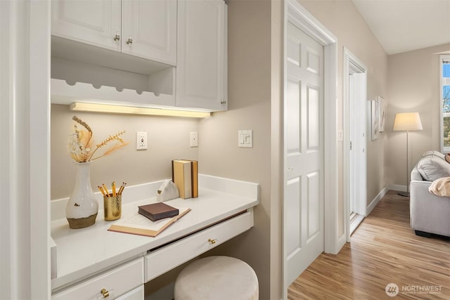 bathroom with wood finished floors and baseboards