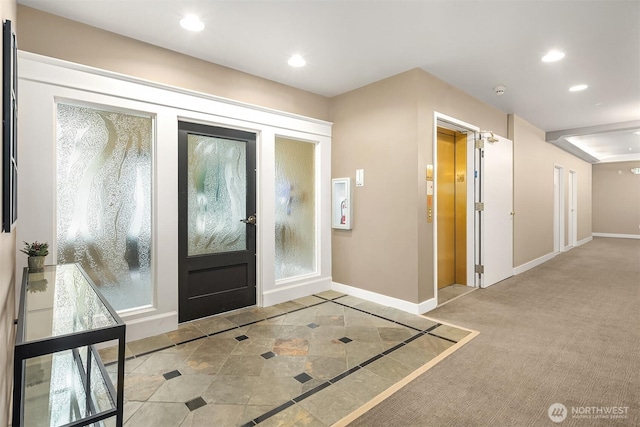 foyer entrance with elevator, recessed lighting, and baseboards