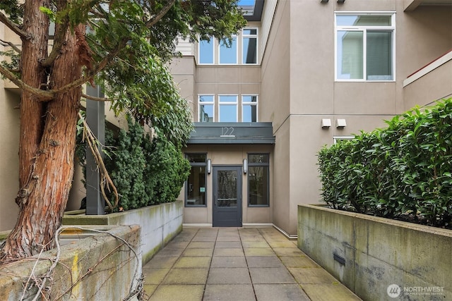 property entrance with stucco siding