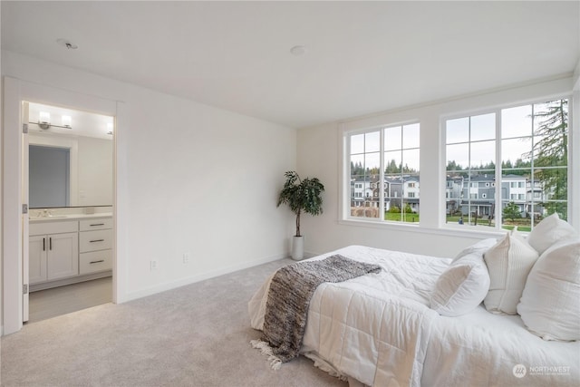 carpeted bedroom featuring ensuite bathroom