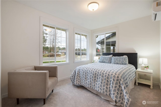 bedroom featuring light colored carpet and a wall mounted AC