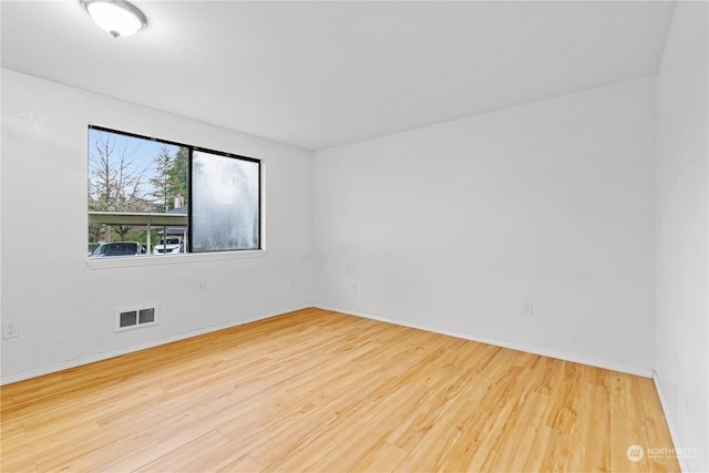 empty room with hardwood / wood-style flooring