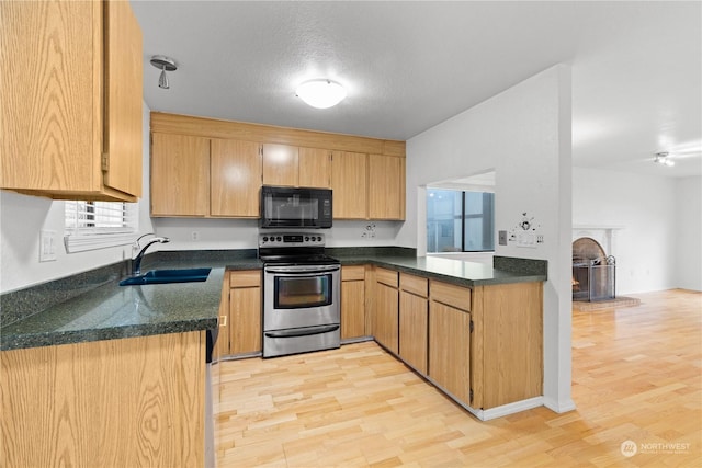 kitchen with kitchen peninsula, light wood-type flooring, a textured ceiling, sink, and stainless steel electric range