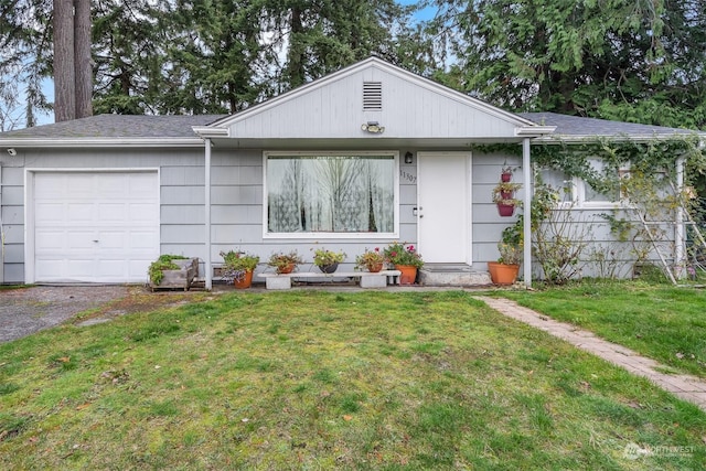 single story home featuring a garage and a front lawn