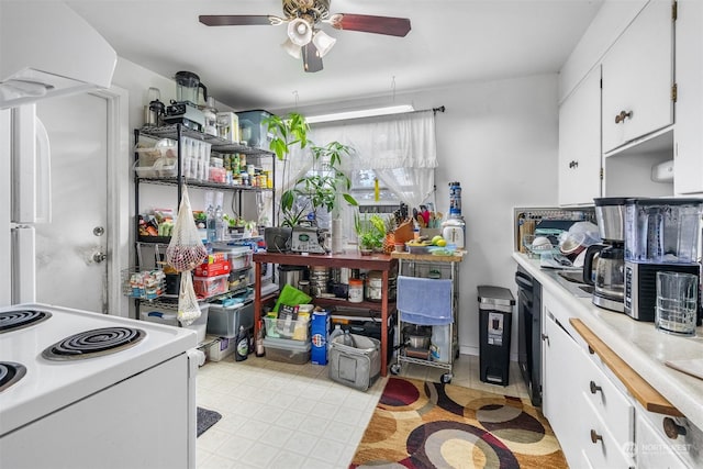 kitchen with white cabinets, ceiling fan, and electric stove