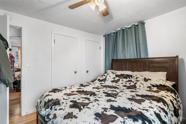 bedroom featuring ceiling fan and light hardwood / wood-style flooring