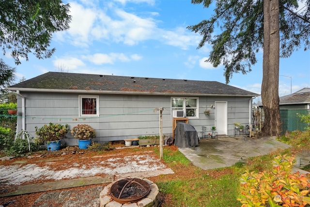 back of house featuring a patio area and a fire pit