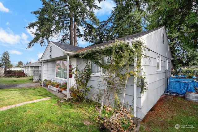 view of side of home featuring a yard