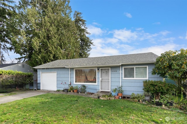 ranch-style house with a garage and a front lawn