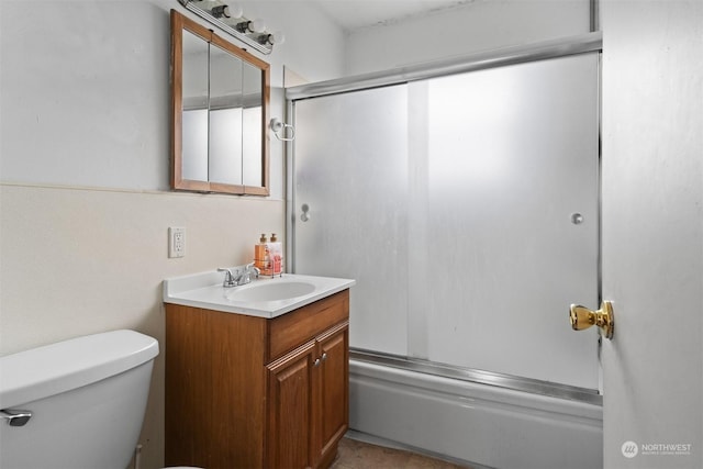 full bathroom featuring shower / bath combination with glass door, vanity, and toilet