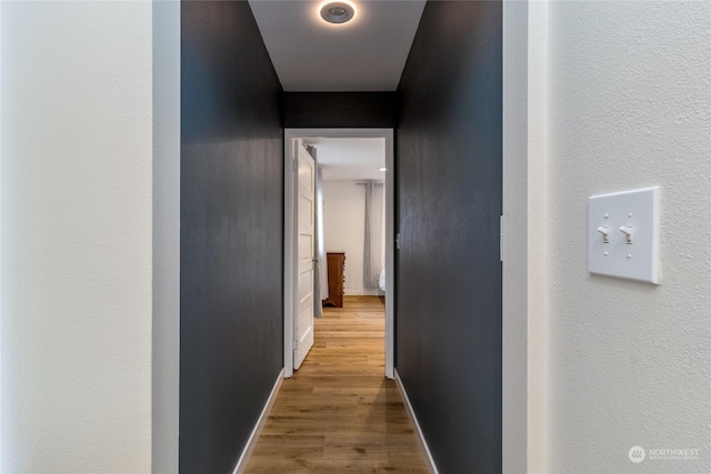 hallway with hardwood / wood-style floors