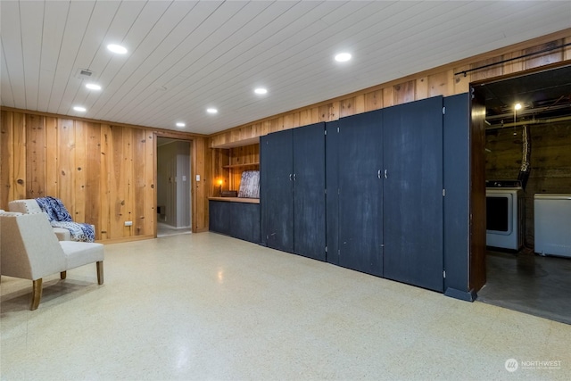 interior space with wood walls and wooden ceiling