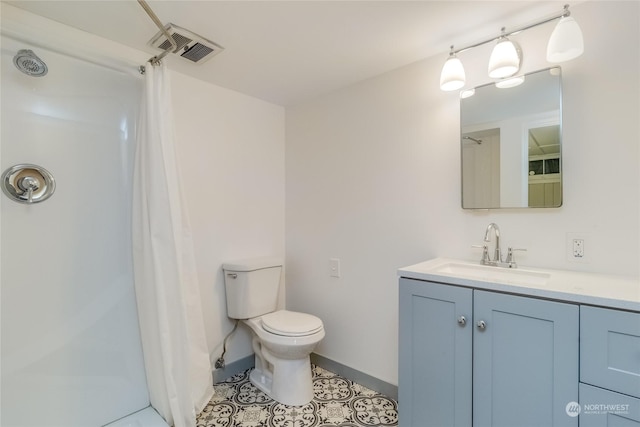 bathroom featuring tile patterned floors, a shower, vanity, and toilet