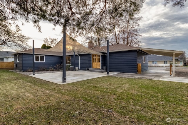 rear view of property with a lawn, cooling unit, and a patio