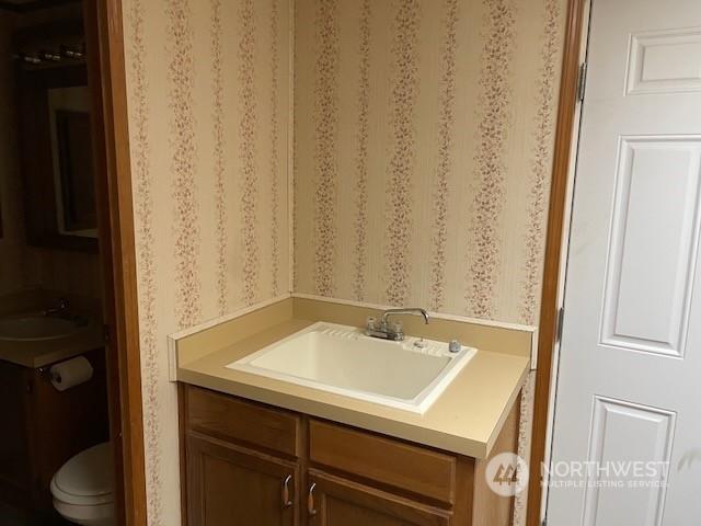 bathroom featuring vanity and toilet