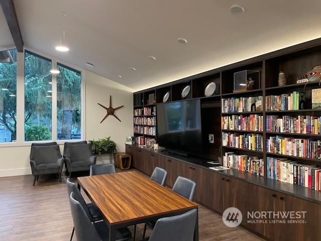 interior space with beam ceiling and light wood-type flooring