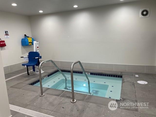 view of swimming pool featuring an indoor in ground hot tub