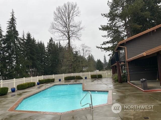 view of swimming pool featuring a patio area