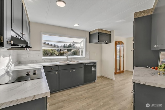 kitchen featuring decorative backsplash, light wood-type flooring, gray cabinetry, sink, and black appliances