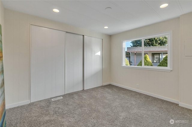 unfurnished bedroom featuring carpet and a closet