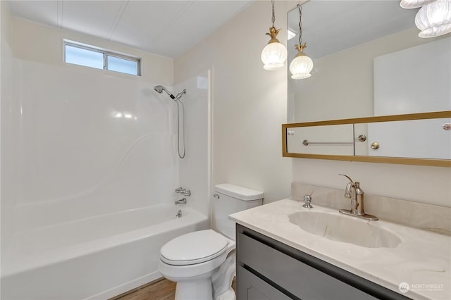 full bathroom with hardwood / wood-style floors, vanity, tub / shower combination, and toilet