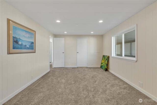 unfurnished room with light carpet