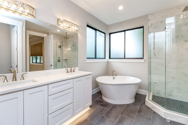 bathroom with vanity and independent shower and bath