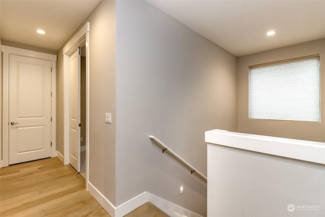 stairway with hardwood / wood-style floors