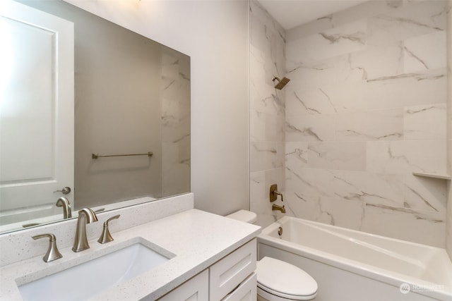 full bathroom featuring toilet, vanity, and tiled shower / bath