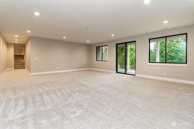 unfurnished room with light colored carpet