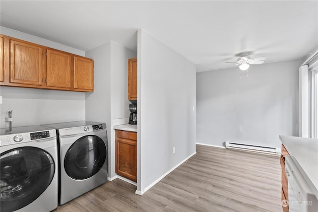 laundry area featuring cabinets, light hardwood / wood-style flooring, washer and dryer, ceiling fan, and baseboard heating