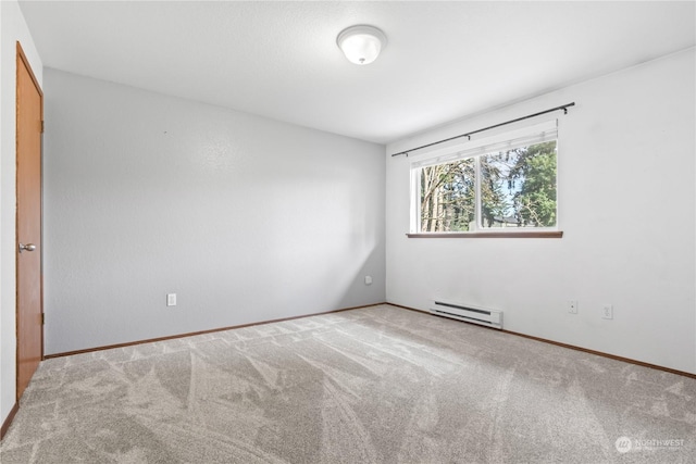 empty room with baseboard heating and carpet floors